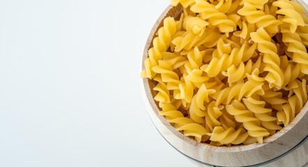 Raw dry uncooked Fusilli pasta spaghetti noodle on white background Good for basil tomato pesto sauce Homemade fresh Italian food organic whole wheat vegan spaghetti noodle for a healthy meal