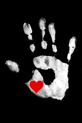 White handprint with red heart on a black background.Together. Palm print as a symbol of racial equality. Stop racism.