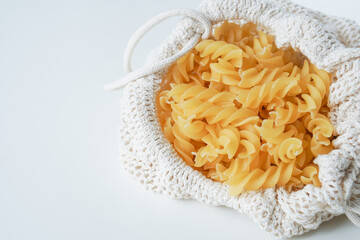 Raw dry uncooked Fusilli pasta spaghetti noodle on white background Good for basil tomato pesto sauce Homemade fresh Italian food organic whole wheat vegan spaghetti noodle for a healthy meal