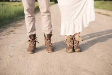 Lovely couple in white clothes and brown shoes standing on the road