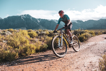 mountain biker racing down a jeep track