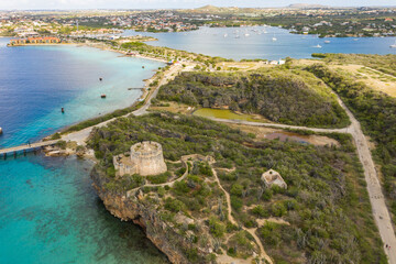 Aerial view of coast of Curaçao in the Caribbean Sea with turquoise water, cliff, beach, beautiful coral reef and Fort Beekenburg