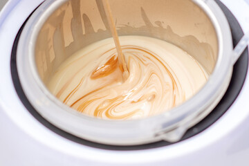 Electric wax warmer or wax heater with melted wax during heating inside bowl