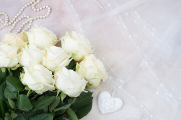 veil, pearl beads, white heart and a bouquet of white roses