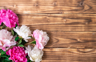 Pink beautiful flowers on braun shabby wooden background. Universal greeting card