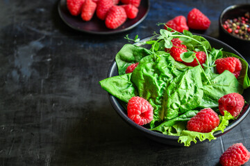 raspberries and lettuce salad, spinach, arugula Menu concept serving size. food background top view copy space healthy eating 