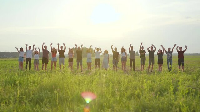 Goodbye Concept. A group of friends at sunset waving.