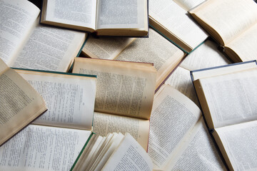 A pile of books lies on the floor