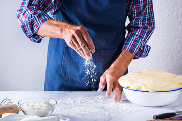 Baking at home concept. Senior man hands cooking, making dough