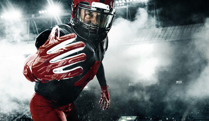 American football player, athlete sportsman in red helmet on dark background with smoke. Sport and motivation wallpaper.