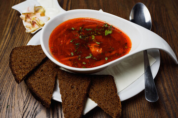 Ukrainian borsch with bacon and dark bread