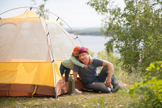 Happy Family Dad And Child On Camping Trip Relaxing Inside Tent. Staycations, Hyper-local Travel,  Family Outing, Getaway.