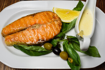 
grilled medium-rare fish with sauce and lemon juice