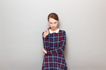 Portrait of serious young woman pointing with index finger at you