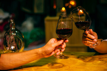 hand holding ice whisky glass, clinking glasses	