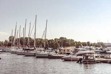 Fototapeta premium A beautiful sailing boats and yachts stand in the port of St. Petersburg in Russia. Blue sky. Summer. The Gulf of Finland
