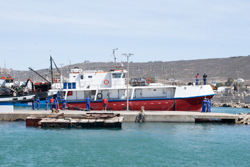 Fishing boats off loading at a harbor. 