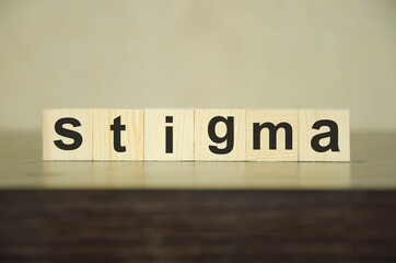  TEXT STIGMA WRITTEN ON WOODEN CUBES AND STAND ON DARK BACKGROUND