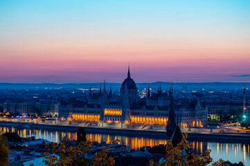 Fototapeta na wymiar Hungarian Parliament Building By Danube River Against Sky At Dusk