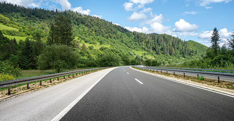 Mountain highway with blue sky and mountains on a background