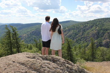 Naklejka premium Happy travelers man and women on the top of mountain. Travel adventure lifestyle success concept hiking active vacations