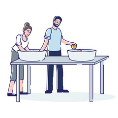 Man and woman washing fruits in basins with water. People cleaning food ingredients before cooking