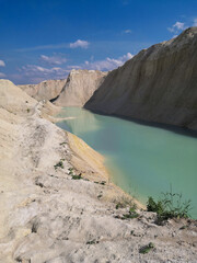 Fototapeta na wymiar Beautiful summer landscape. Turquoise water between sand mountains in the desert.
