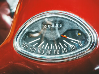 Closeup photo of a red speedometer of an old motorcycle