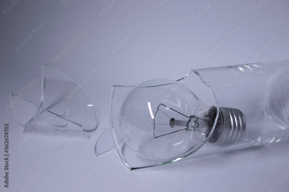 Wall mural light bulb in a broken glass on a white background. copy space. isolated. high quality photo