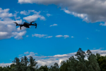 Fototapeta na wymiar Frankfurt, Germany - 30th June 2020: A german photographer testing his new drone DJI Mavic Air 2, taking pictures of it while flying.