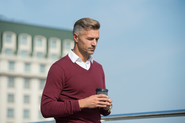 Harmony and life energy balance. Relax and recharge. Pleasant moments. Tranquility. Coffee break. Drinking coffee on the go. Handsome guy hold coffee cup sky background copy space. Self care