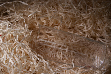 a broken glass lies in the hay. Copy space. High quality photo