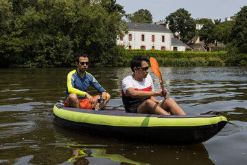 TWO MEN DOING KAYAK IN RIVER