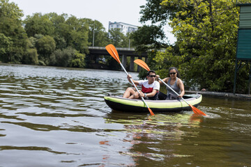 MAN AND WOMAN KAYAKING IN RIVER