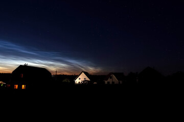 Fototapeta na wymiar Noctilucent clouds in rural location 