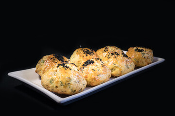 Homemade Pastry in white serving plate. On black background