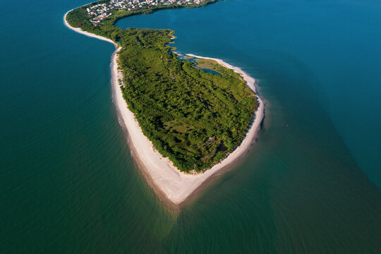 Brazil, Florianopolis. Panoramic aerial view of Daniela beach pontal peninsula and river showing sea, sand and trees.