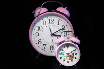 Large and small table top classic analog Clock. On black background