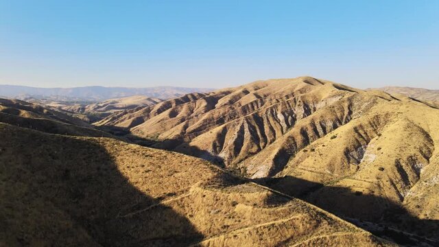 Drone shot of California mountain range during sunset on a beautiful day with clear skies