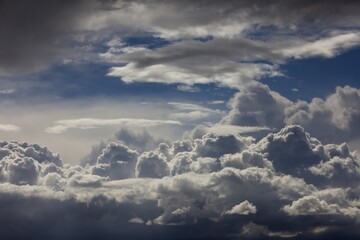 Dramatic clouds form in a blue sky.