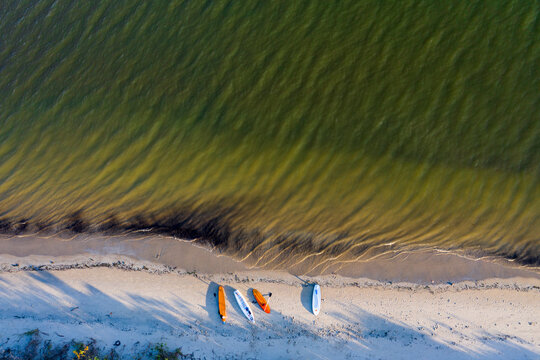 Brazil, florianopolis. Panoramic aerial view of Daniela beach pontal peninsula and river with colorful small boats on the sand shore.