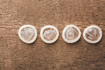 opened condoms on the wooden background