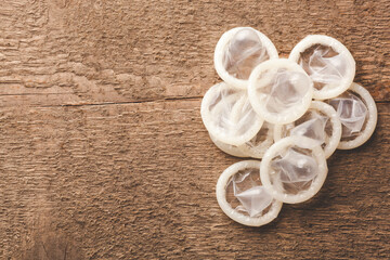 opened condoms on the wooden background