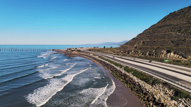 Drone shot of ocean along pacific highway in California on a sunny day