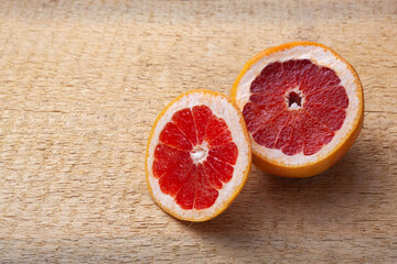 Fototapeta na wymiar Fresh red sliced pomegranate and grapefruit On a wooden background.