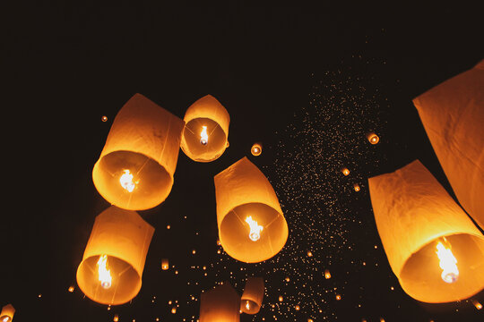 Low Angle View Of Illuminated Paper Lanterns Flying Against Sky At Night
