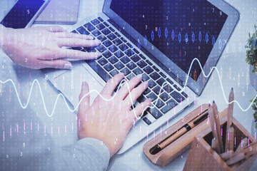 Double exposure of woman hands typing on computer and forex chart hologram drawing. Stock market analysis concept.