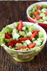 summer salad with strawberries, avocado,   green peas. copy space