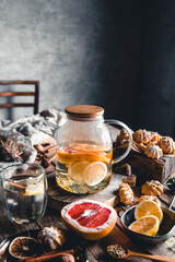 Hot tea with slices of fresh grapefruit on wooden tablet. Healthy drink, Eco, vegan