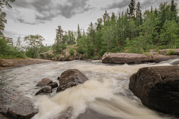 spring waterfall flowing through rocks- a perfect scenery for magazine cover page